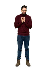 Full-length shot of Handsome man with glasses scheming something on isolated white background