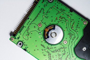 Winchester of green color. Hard drive. Motherboard. Computer spare parts. Memory card. Diskette. On a white background. 