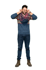 Fototapeta premium Full-length shot of Hippie man covering ears with hands. Frustrated expression on isolated white background