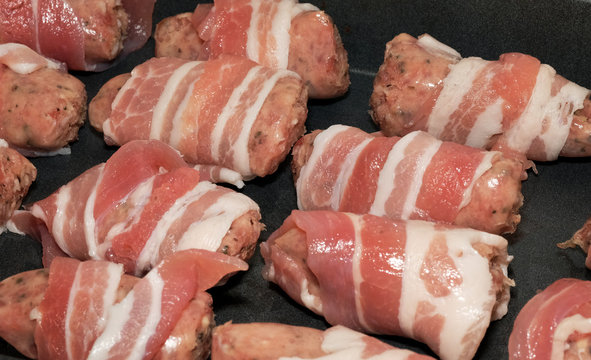 Pigs in Blankets. Small pork sausages wrapped with backon ready to cook.