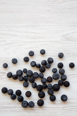 Top view, blueberries on a white wooden background. Copy space.