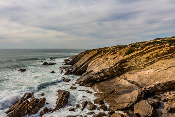Beautiful view over cliffs and rocks in the ocean. Cloudy day. Nature scenery.