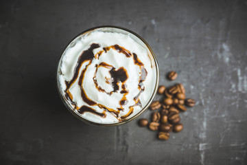 Sweet creamy latte on rustic background. Selective focus. Shallow depth of field.
