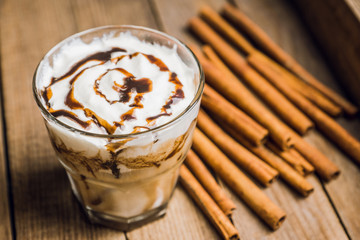 Sweet creamy latte on rustic background. Selective focus. Shallow depth of field.