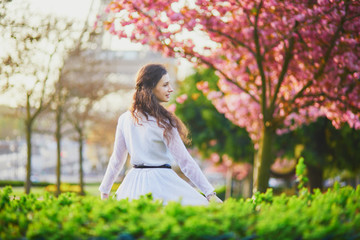 Woman enjoying cherry blossom season in Paris, France