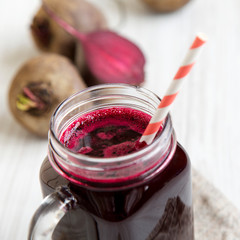 Beetroot smoothie in glass jar mug, side view. Close-up.