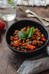 Vegetable Stew with Beans, Mushrooms and Tomatoes on a wooden background