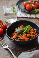 Vegetable Stew with Beans, Mushrooms and Tomatoes on a wooden background