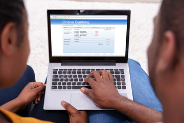Fototapeta na wymiar Couple Doing Online Banking On Laptop