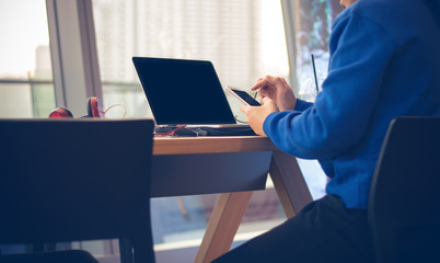man touch smartphone screen in coffee shop with social network business concept