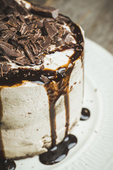 Fresh chocolate cake on the dark rustic background. Selective focus.