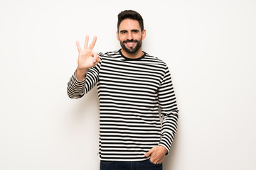 Naklejka premium handsome man with striped shirt happy and counting three with fingers