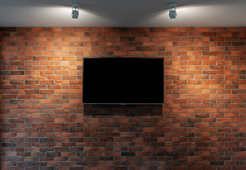 Modern TV with blank black screen, hanging on red brick wall