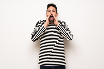 handsome man with striped shirt shouting and announcing something