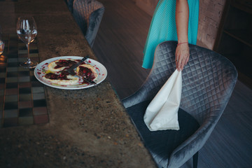 Elegant woman leaves a napkin after dinner.