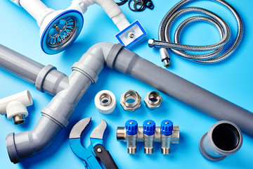 plumbing tools and equipment on blue background top view.