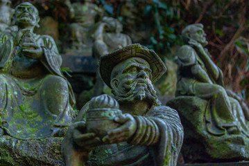 Fototapeta na wymiar many old monk statues of Buddha in Japan 