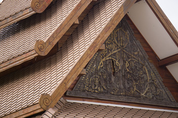 Thai wood carving pattern roof background.