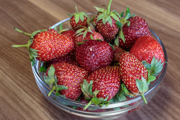 Fresh strawberry in the glass bowl closeup. Concept of a vegan breakfast.
