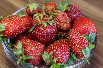 Fresh strawberry in the glass bowl closeup. Concept of a vegan breakfast.