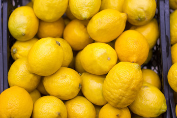 Ripe yellow lemons, background, texture