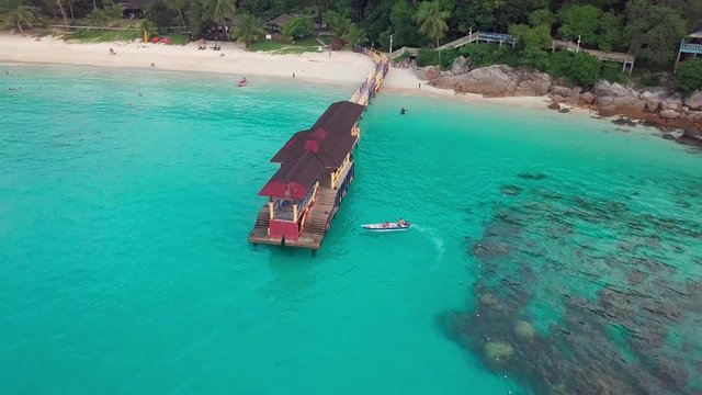 Sunrise aerial view of a boat on crystal clear waters at Perhentian Islands (Pulau Perhentian)