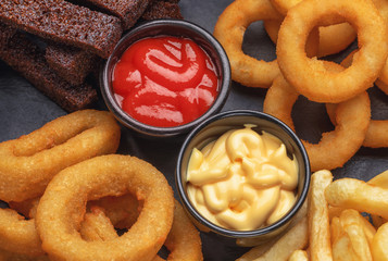 tomato and cheese sauce on a beer plate with squid and potatoes and bread. cafe and restaurant menu. beer snack