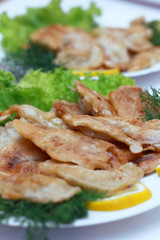  chicken breasts on a leaf of lettuce with greens