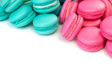 Sweet almond colorful tiffany colored blue  and living coral macaron or macaroon dessert cake isolated on white background. French sweet cookie. Minimal food bakery concept. Flat lay copy space