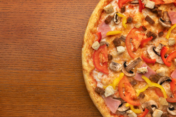 half a portion of pizza with mushrooms on a wooden table. place for text and copyspace.