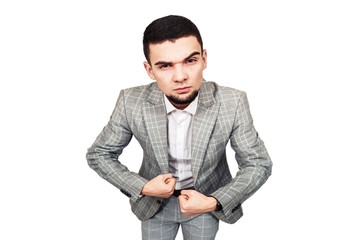 self-confident businessman. Stylish young bearded guy in a gray suit shows his biceps