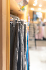 Multi-colored pants hung on the rack for sale in department stores.