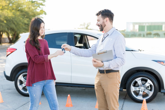 Learner Receiving Keys Of Car From Instructor