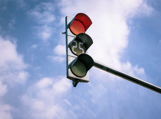 red light switched on traffic lights, 25 seconds until switching to amber lights. Cloudy blue sky...