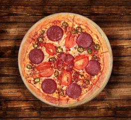 Isolated image of a pizza Devil on a wooden background