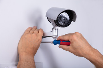 Technician Fixing Security Camera