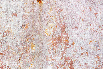 Cracked gray paint on rusted metal. Brown background with rusty metal. Iron.