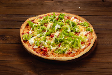 Appetizing pizza on a wooden background