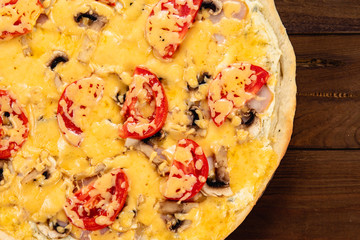 Appetizing pizza on a wooden background