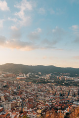 Cityscape and mountains sunset view from Bunkers Del Carmel, in Barcelona, Spain