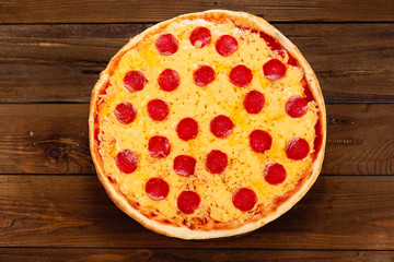 Appetizing pizza on a wooden background