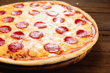 Appetizing pizza on a wooden background