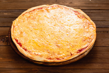 Appetizing pizza on a wooden background