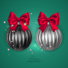 Realistic black and white christmas balls with red bow on green background, vector christmas decorations