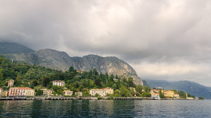 Naklejka premium View of village in forest in Lake Como from ferry at sunset, Lake Como, Italy