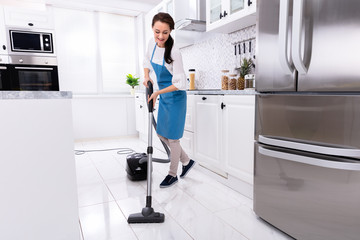 Janitor Cleaning Kitchen Floor With Vacuum Floor