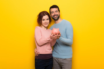 Couple in valentine day holding a piggybank