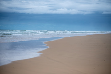 clear blue sky with waves in background