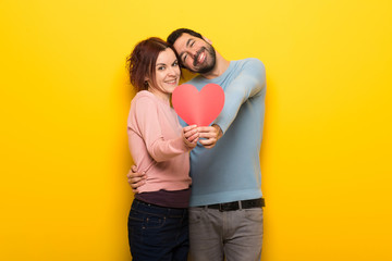 Couple in valentine day holding a heart symbol