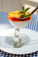 apricot dessert with jelly and milk cream, decorated with mint